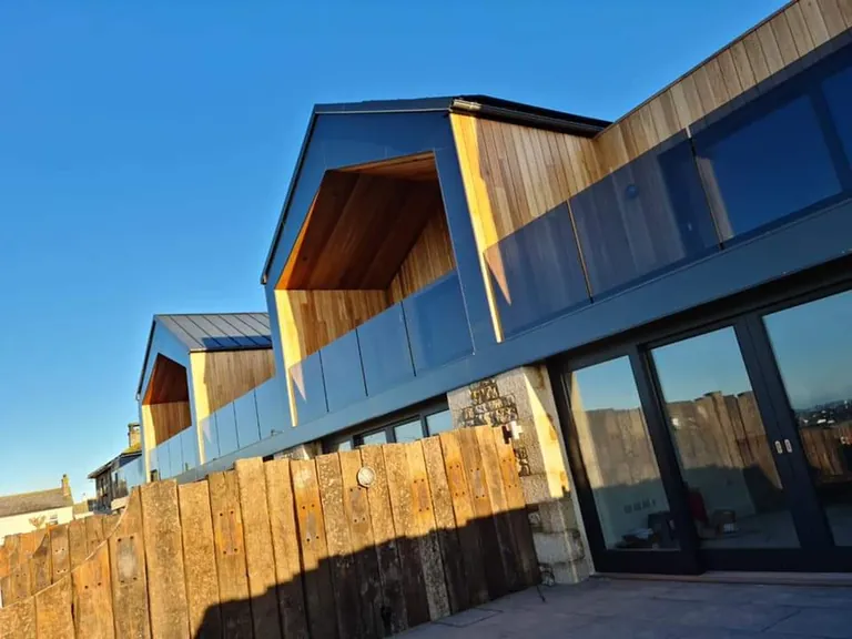 Cedar-clad gables with a glass balustrade