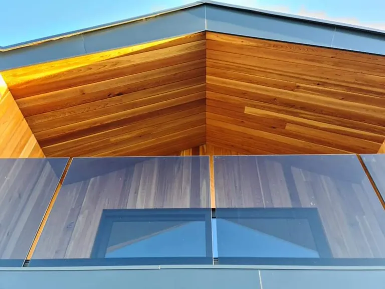 Cedar soffit and cladding above glazing