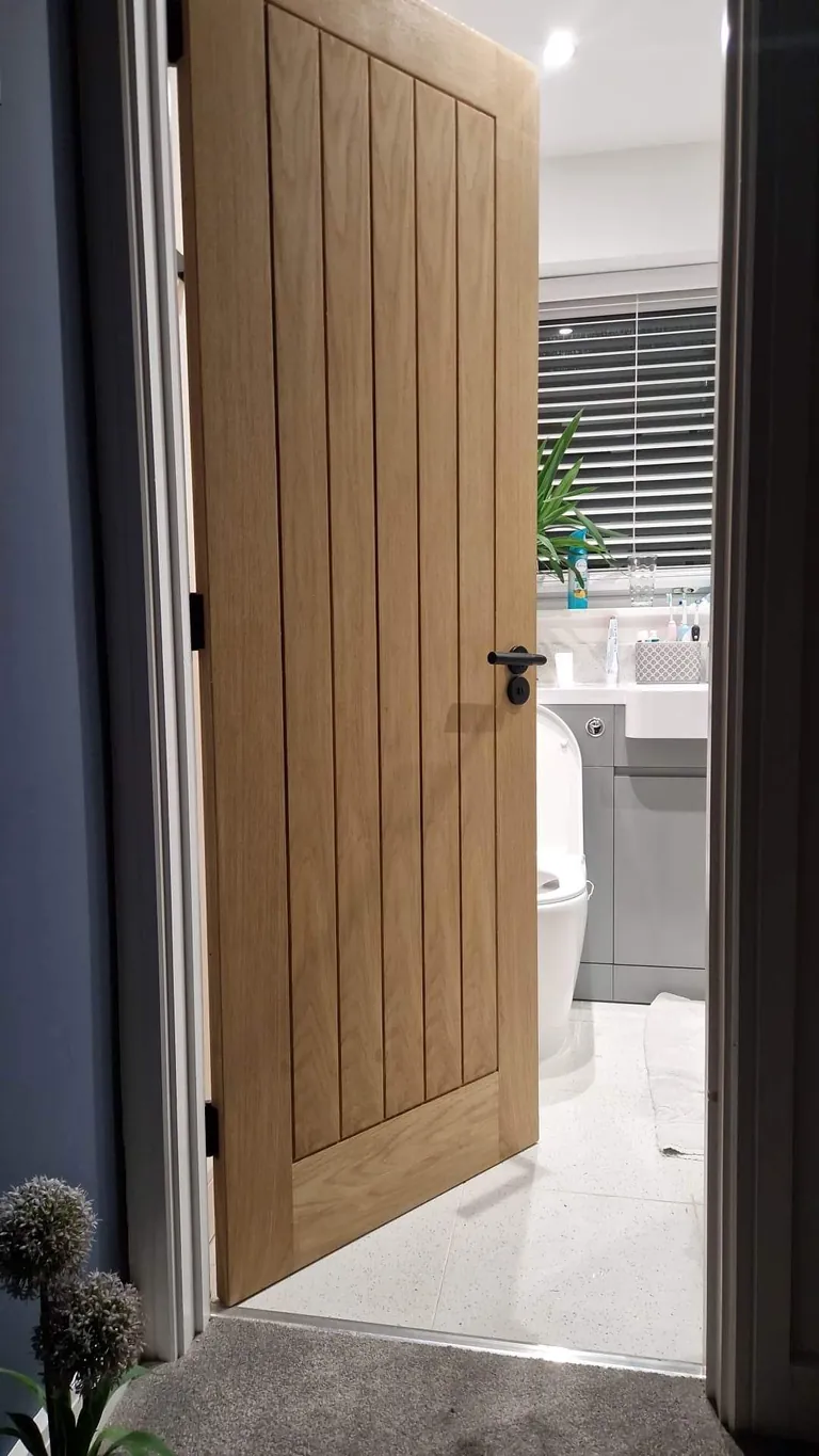 Oak door hung into a bathroom doorway