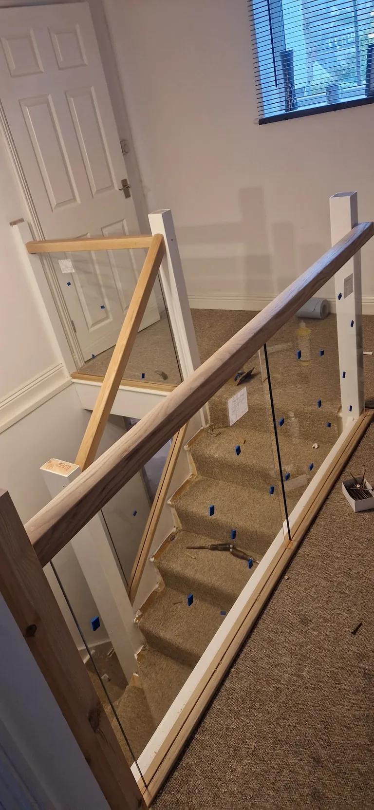 Staircase with glass balustrade and oak handrail